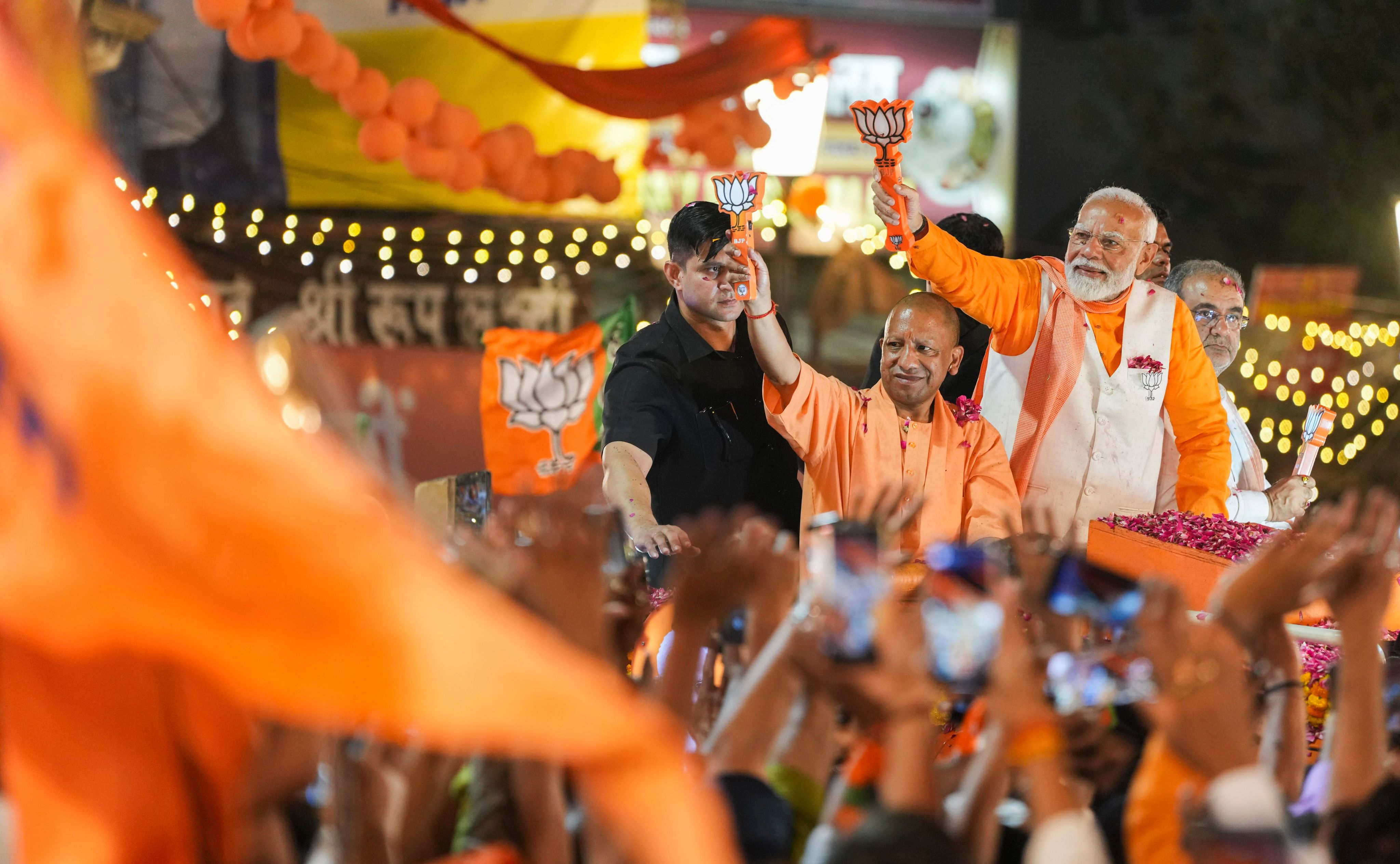 Prime Minister Narendra Modi with Uttar Pradesh Chief Minister Yogi Adityanath during a road show for Lok Sabha elections, in Varanasi. Credit: PTI File Photo