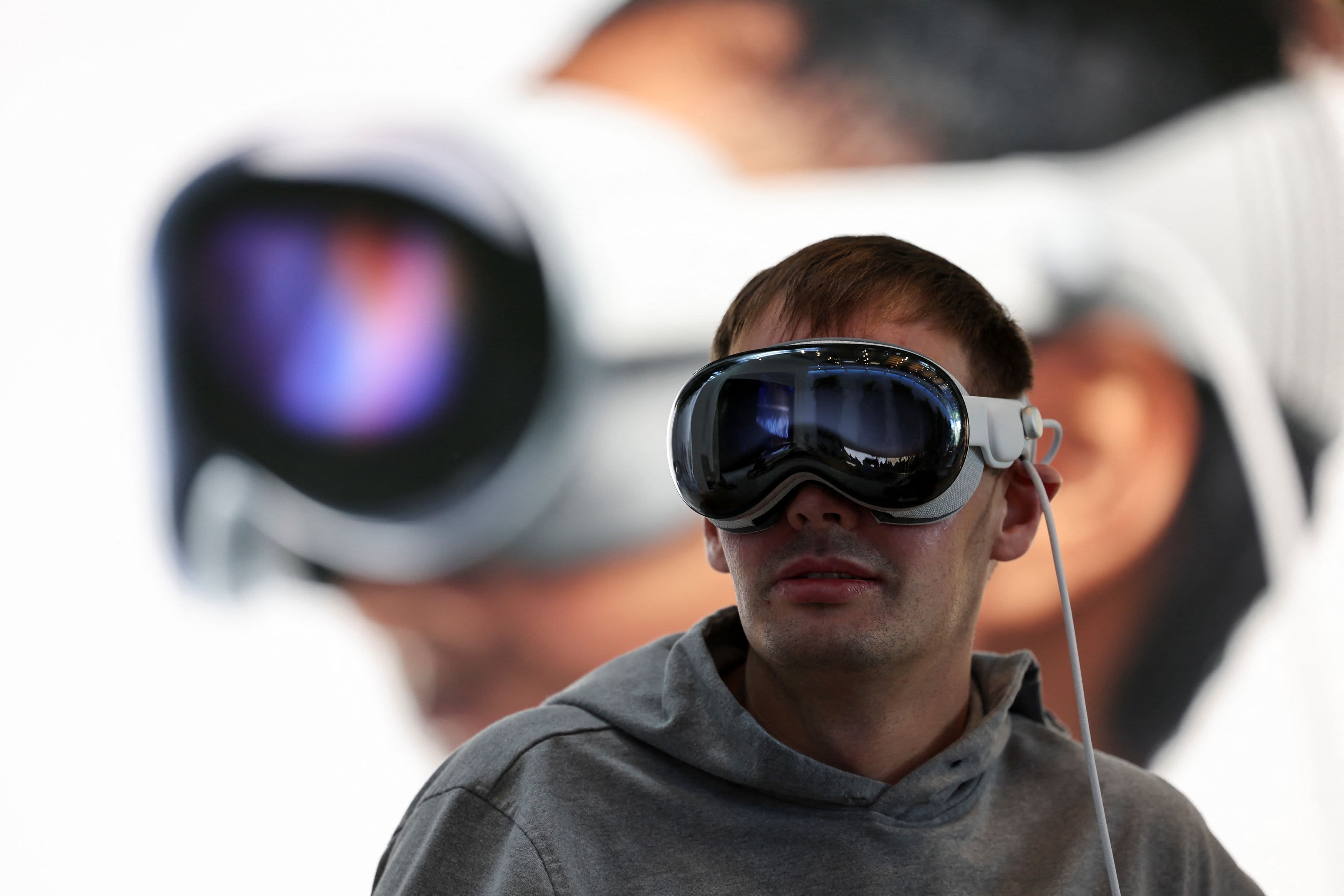 A customer uses Apple's Vision Pro headset on the day it goes on sale for the first time in Los Angeles, California, February 2, 2024. Credit: Reuters Photo