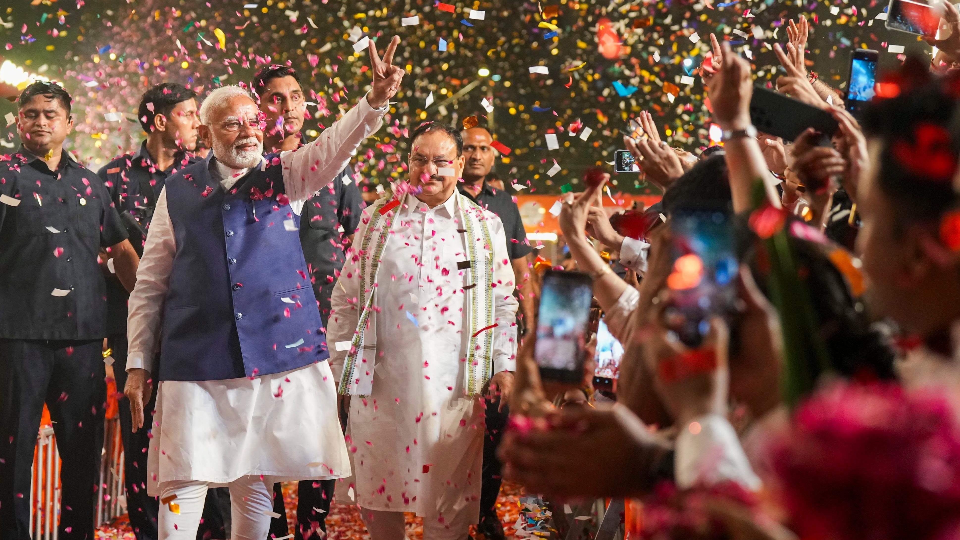 Prime Minister Narendra Modi and BJP National President JP Nadda greet supporters upon their arrival for a meeting at the party headquarters as the party leads in the Lok Sabha elections amid the counting of votes, in New Delhi, Tuesday, June 4, 2024. Credit: PTI Photo