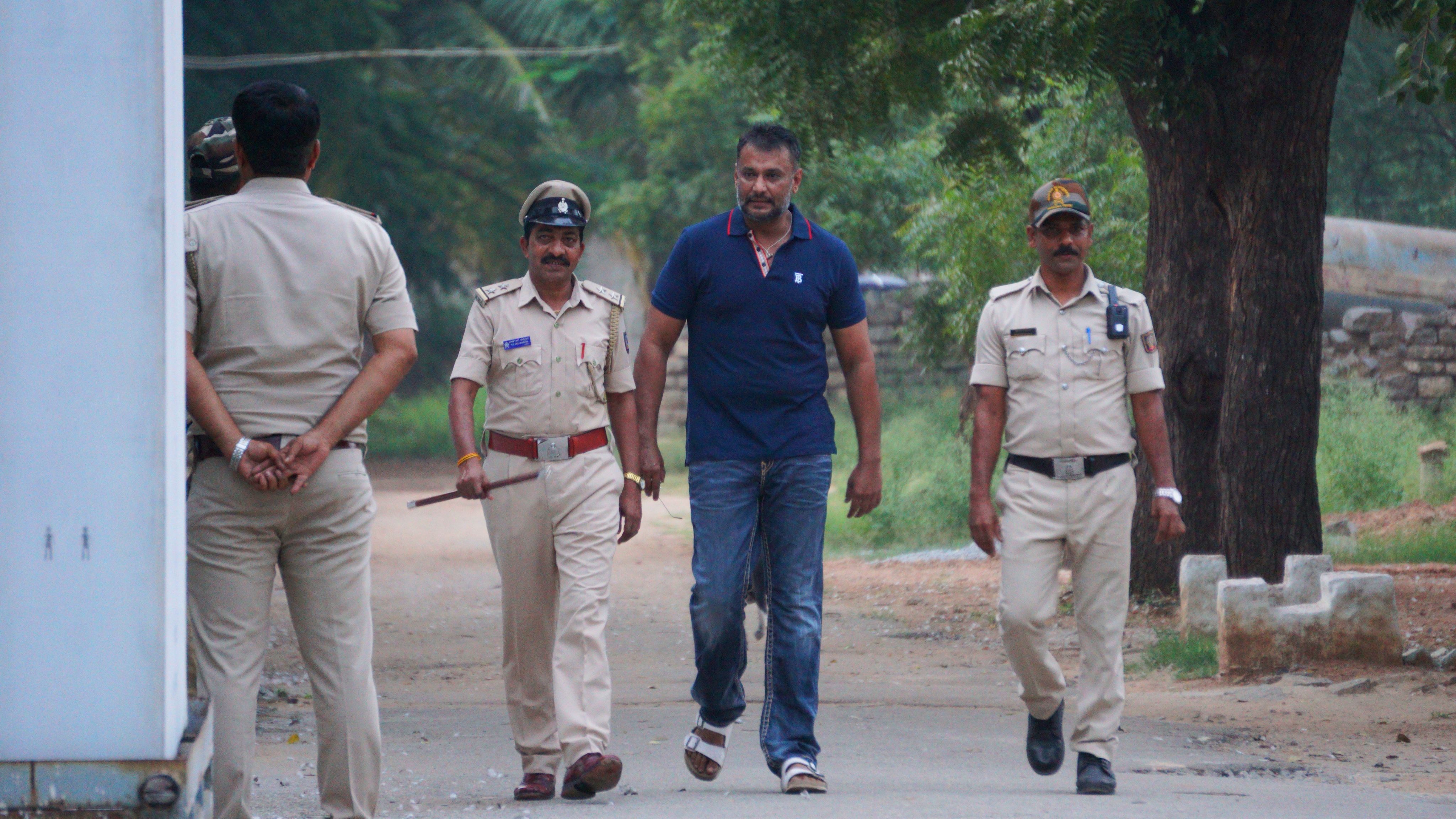 Kannada actor Darshan being escorted by the police. Credit: DH File Photo